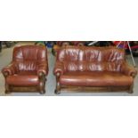 A stained oak framed leather two piece suite comprising of 3 seater settee 187 cm wide and an