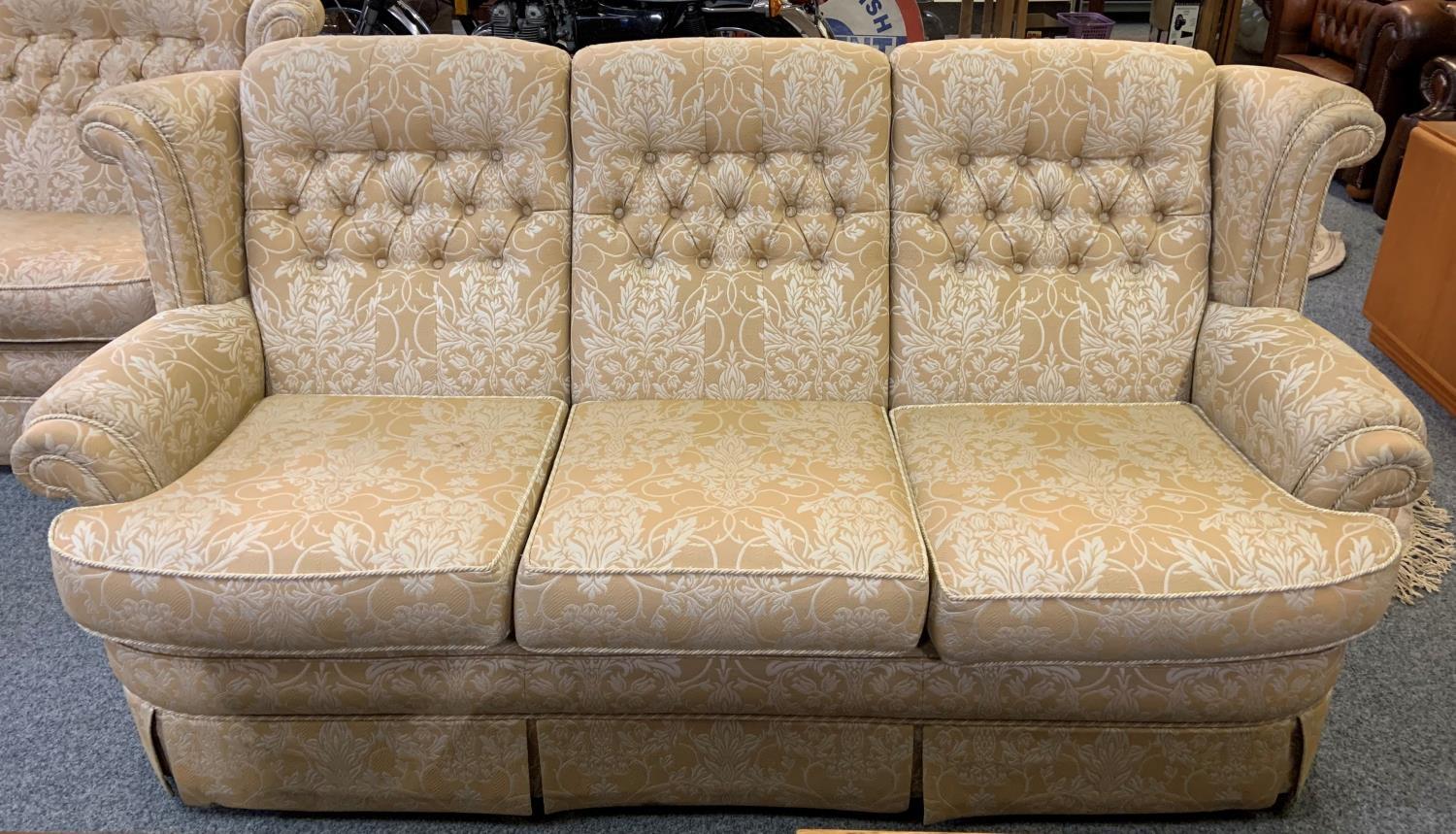 A two piece suite comprising a 3 and 2 seater settees in button back light brown fabric, 175 and 204