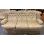 A two piece suite comprising a 3 and 2 seater settees in button back light brown fabric, 175 and 204