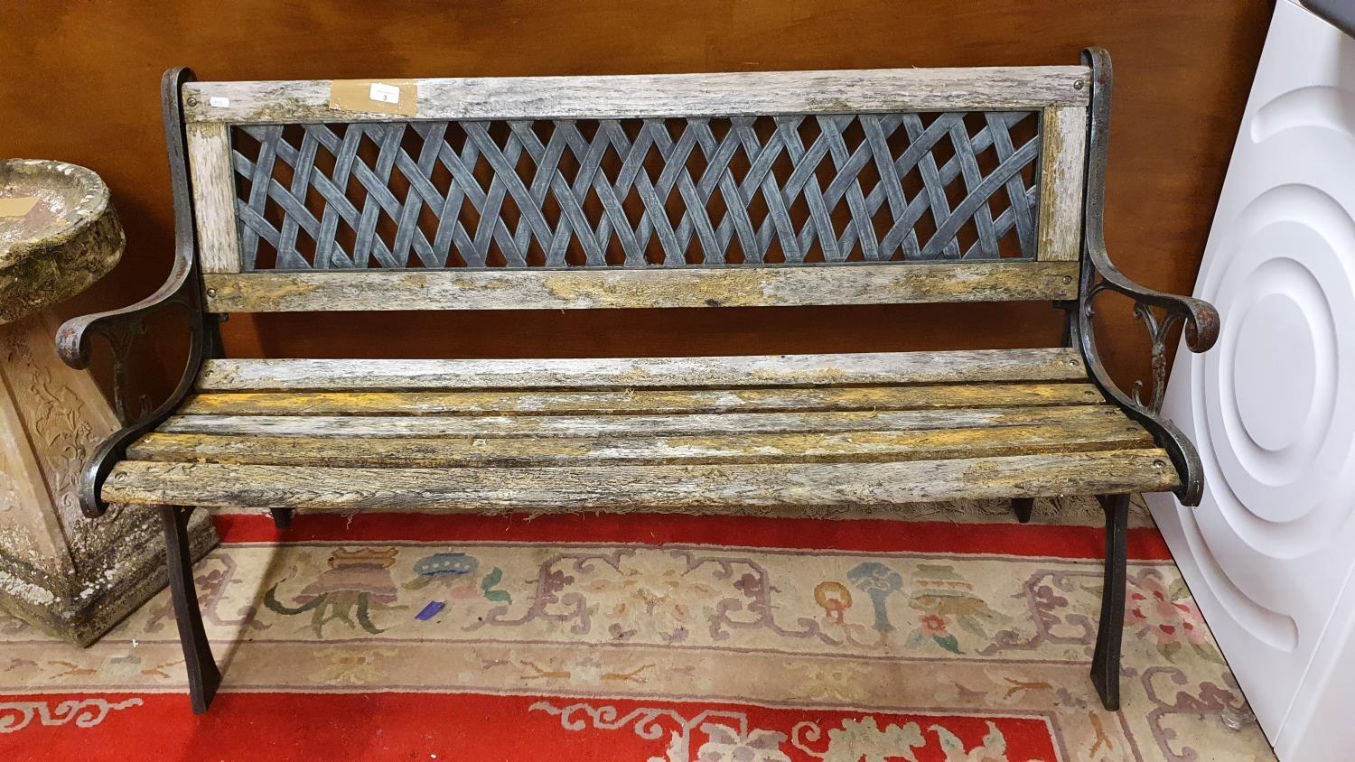 A cast alloy and wood slat garden bench.