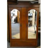 A mahogany double wardrobe with mirrored doors over single base drawer, both sides providing full