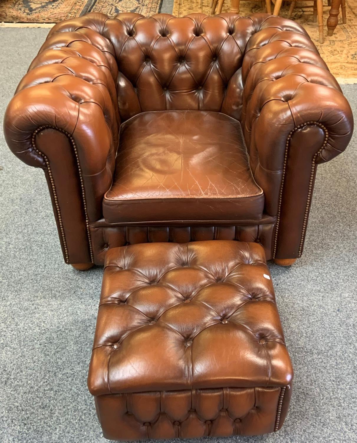 A Chesterfield style armchair in brown button back leather with similar box footstool (2).