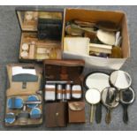 A box of cased and loose brush sets and mirrors.