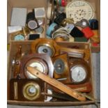 A box full of mainly barometers, a selection of compacts and a box of travel and alarm clocks (3).