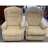 A pair of manual reclining armchairs.