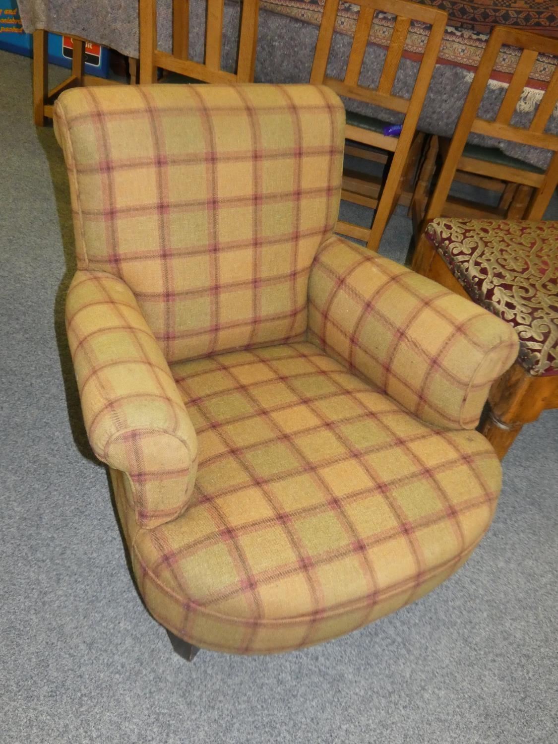 A 19th century mahogany framed generous arm chair, upholstered in tartan fabric.
