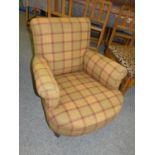 A 19th century mahogany framed generous arm chair, upholstered in tartan fabric.