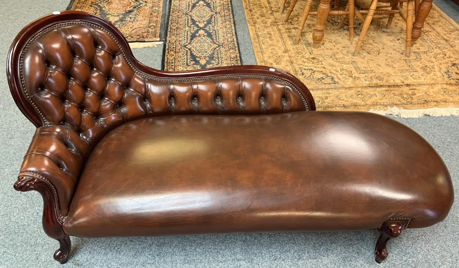 A brown leather button back chaise lounge 170 cm wide.