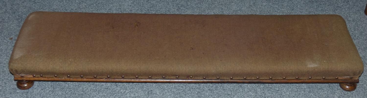 A long Victorian footstool 125 cm wide in brown fabric.