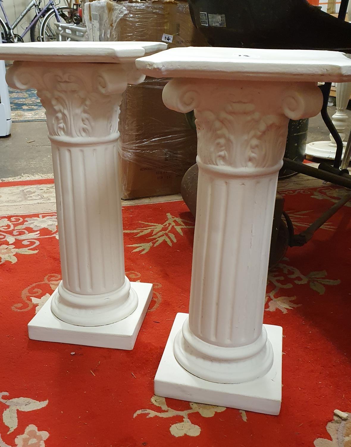 A pair of painted pottery Corinthian columns, 56 cm.