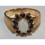 A 9ct gold opal and sapphire cluster ring, 2.7gms, size O