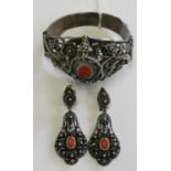 A low grade silver and coral filigree bracelet with matching ear pendants, a natural sea shell