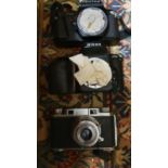 A Nikon F50 camera body, a Pentax P30 SLR camera body, a Konica camera, and other camera equipment
