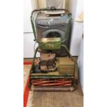 An Atco Royale B24 hand start lawn mower with sit on attachment, serial number 1836210219,