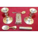 A sterling silver pair of desk candlesticks, loaded, an Edwardian silver trinket box, Birmingham
