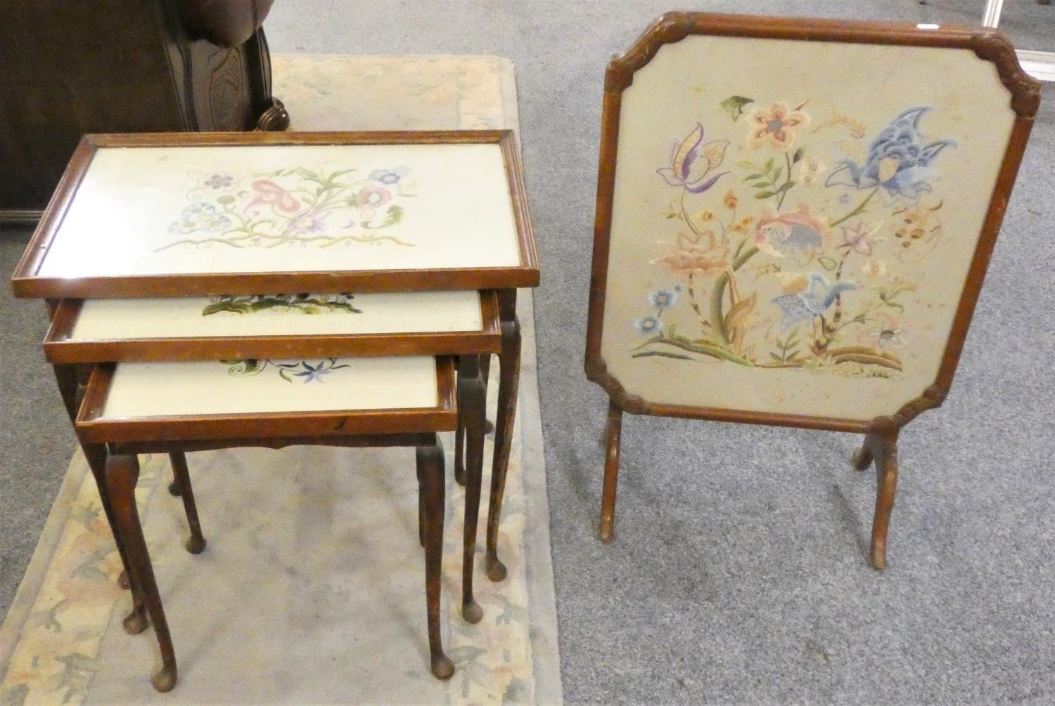 A mahogany fire screen table, the panel embroidered behind glass together with a nest of tables with