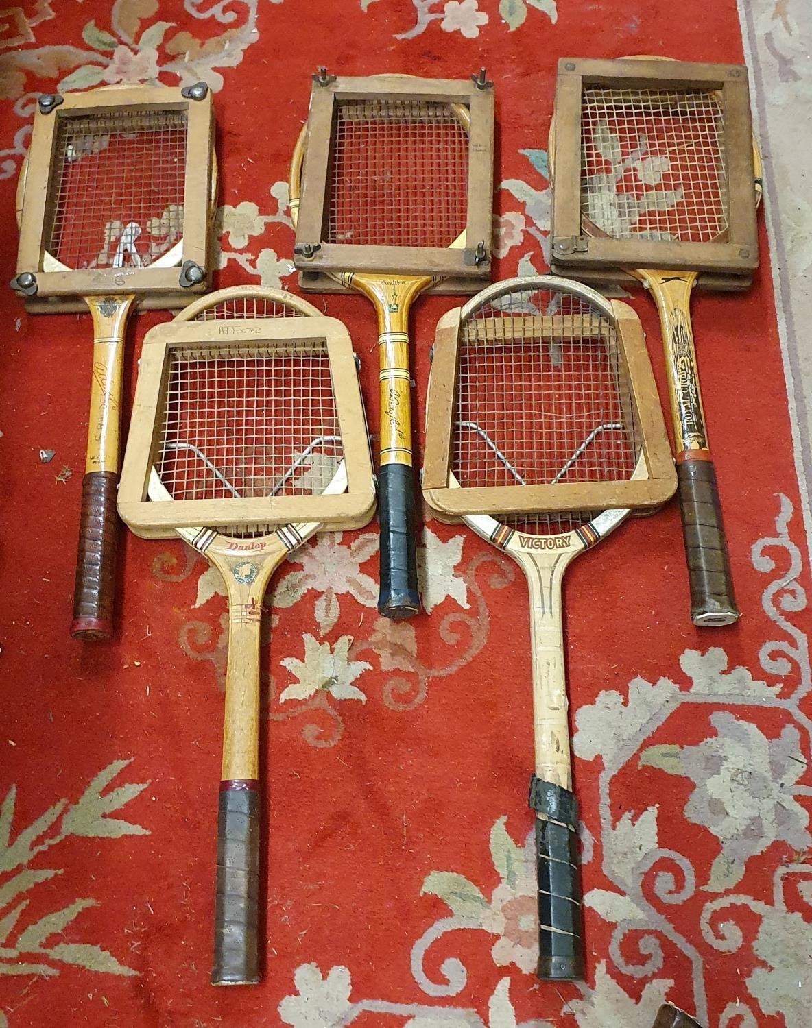 Five wood framed tennis rackets, with clamps, other wooden rackets and a collection of golf clubs