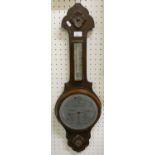 An oak framed barometer in need of new glass.