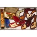 A collection of eight carved Meerschaum pipes, to included a hand holding the bowl, a claw holding