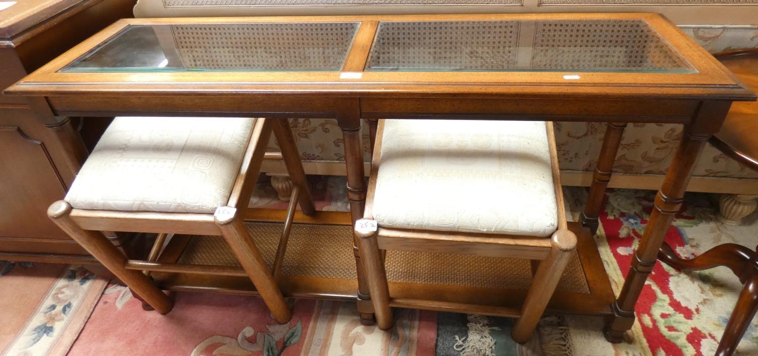 A mahogany side table, the top with two glazed bevel edged panes over a cane effect under tier,