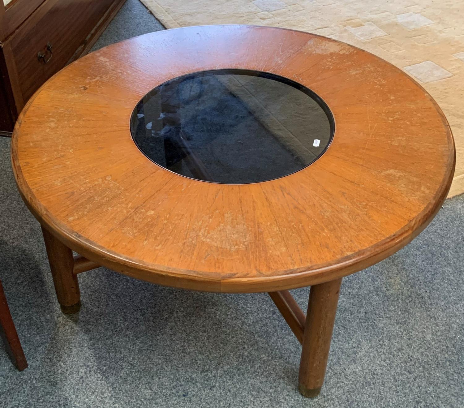 A teak circular coffee table 97 cm diameter with central glass insert together with a smaller