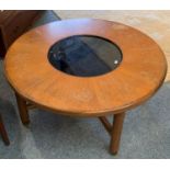 A teak circular coffee table 97 cm diameter with central glass insert together with a smaller