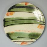 Sandy Brown (b.1946), a circular plate with bold brushwork and trailed decoration, signed to the