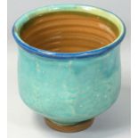 A glazed stoneware chawan of cylindrical form, painted with shades of blue with a cobalt rim,