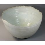 Jack Kenny, a large deep stoneware bowl with wavy rim covered in matt white glaze, impressed S mark,