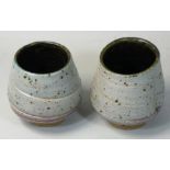 Charles Bound (b.1939), a pair of stoneware tea bowls, ribbed pattern on a mottled cream ground,