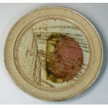 Mick Arnup, a stoneware abstract pattern plate, speckled pattern to the rim and face on a grey