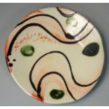 Sandy Brown (b.1946), a circular plate with bold brushwork and trailed decoration, signed to the
