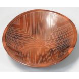 Siddig El Nigoumi (1931 - 1996), an earthenware burnished clay circular dish, mottled brown and