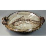 Charles Bound (b.1939), a large twin-handled dish with hand worked fish decoration, on a mottled