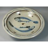 A large stoneware dish with abstract fish decoration, unknown artist, in tones of blue, cream and