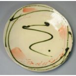 Sandy Brown (b.1946), a circular plate with bold brushwork and trailed decoration, signed to the