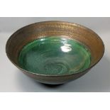 Nick Booth (contemporary), a large studio pottery bowl, with brass patinated rim and polychrome