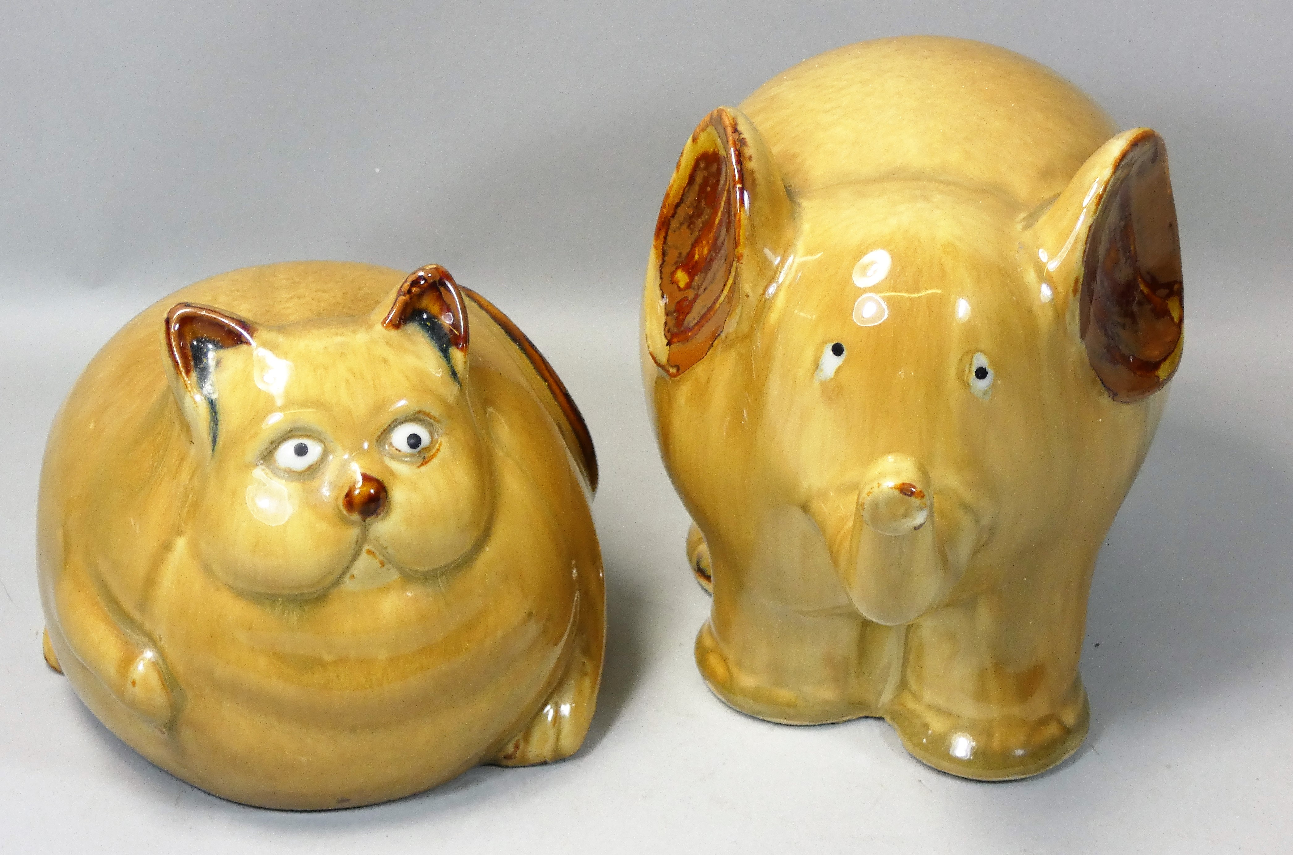 A studio pottery glazed model of a comical cross-eyed overweight cat, height 12cm, together with