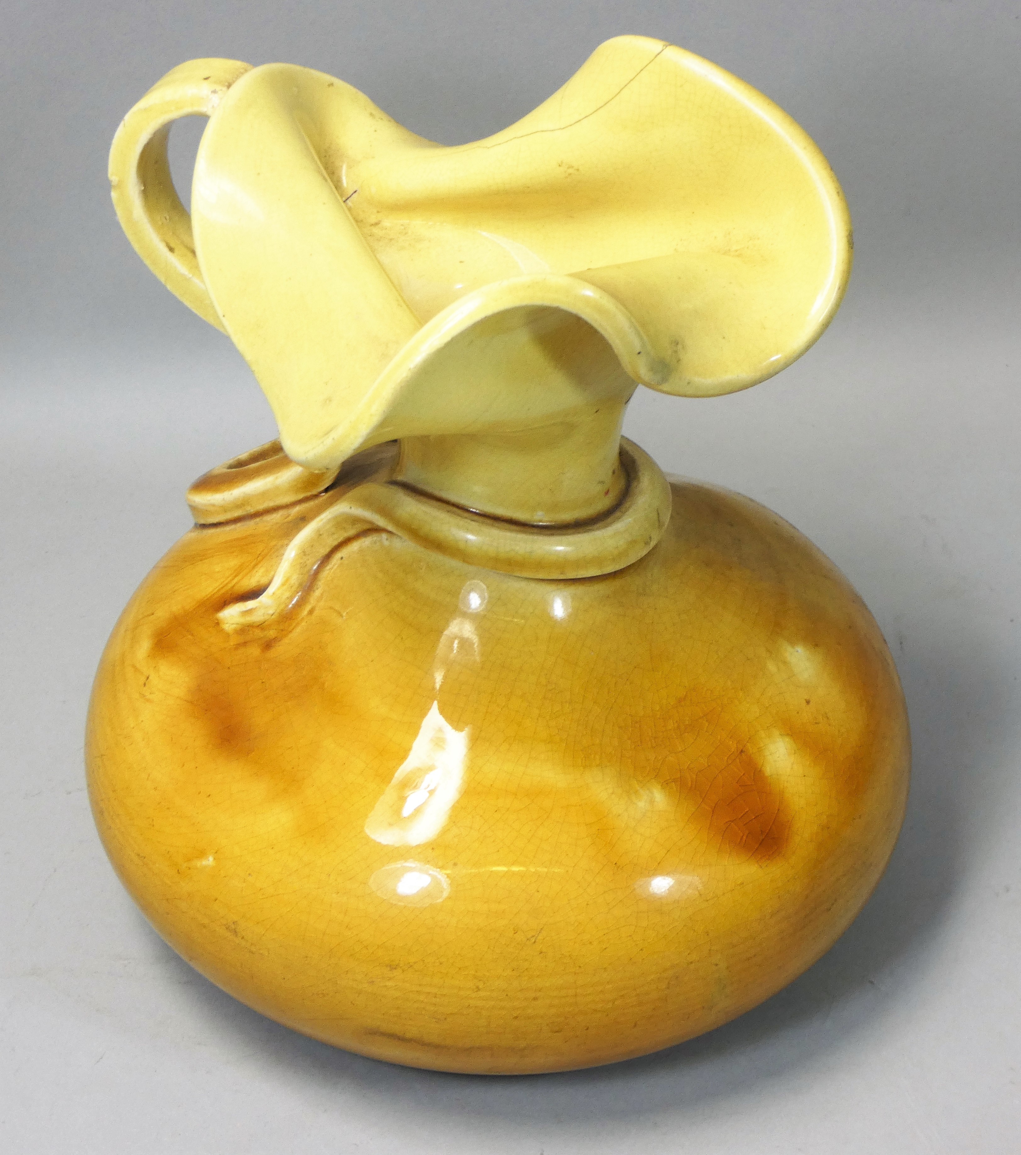 J R Mally, an 'Old London Ware' studio art pottery distorted yellow squat vase, in the form of a jug