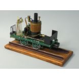 A live steam gas fired model of a vertical boiler locomotive, on an oak track, length 19cm.