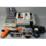A Nintendo NES games console, together with a Nintendo SNES games console, power supply,