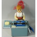 A vintage battery operated tin plate and plastic typing secretary 'Miss Friday', height 18cm.