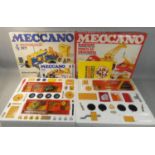A collection of Meccano housed within a red painted wooden carry cat, together with two boxed
