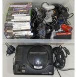 A boxed 16-bit Sega Megadrive, a quantity of original Xbox and PlayStation 2 games and a selection