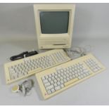 An early Macintosh SE FDHD personal computer, together with two keyboards, mouse, power cable and