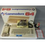 A boxed Commodore 64C personal computer, with power supply unit, manual, television lead, tape desk,