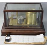 A mahogany cased brass barograph, with chart drawer, quantity of graphs and blue recorder ink.