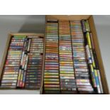 Approximately one hundred and sixty Commodore 64 cassette tape games in small cases, most with