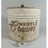 A 'Nestle Cream' tin container of semicylinder form, with tap to the front, height 25cm.