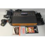 An Atari 2600A nicknamed Woody, with power supply unit, two original controllers, combat cartridge